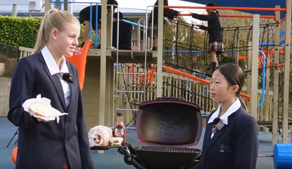 Video thumbnail: students and families sharing a meal at a school event